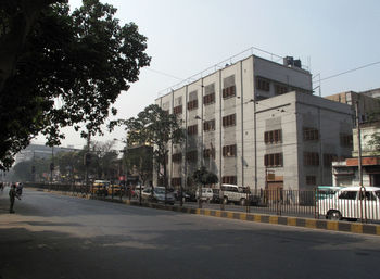 City street by buildings against sky