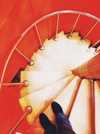 Low section of person on spiral staircase