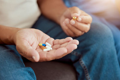 Midsection of woman holding pills