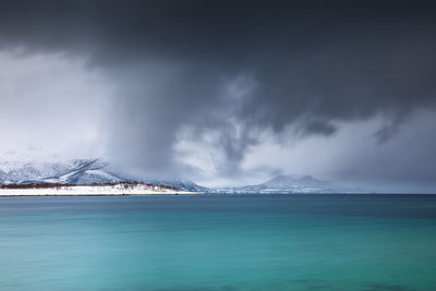 View of tranquil lake against snowcapped mountain