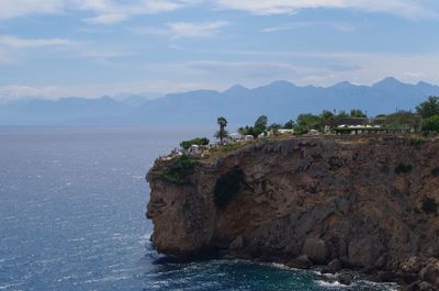 Scenic view of sea and mountains against sky