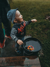 High angle view of boy looking at camera