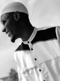 Close-up of smiling of young man wearing skull cap at home