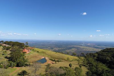 Scenic view of landscape against blue sky