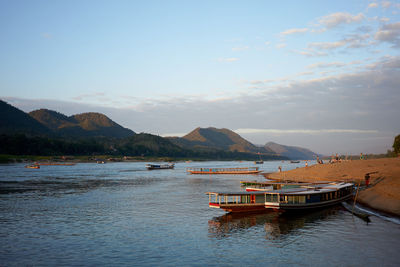 Boats moored on sea against sky