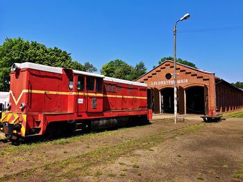 Train on railroad track against clear blue sky