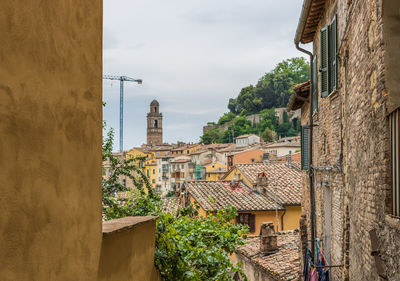 Buildings in town against sky