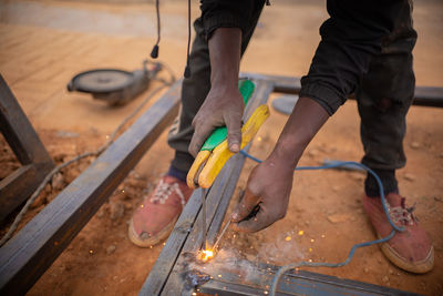 Midsection of man working on wood