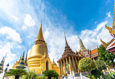 Low angle view of pagoda against building and sky