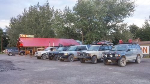 Side view of cars parked on road