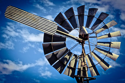 Low angle view of traditional windmill against sky