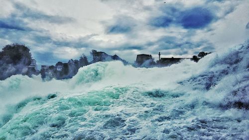 Panoramic view of waves in sea against sky