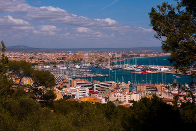 High angle view of townscape by sea against sky