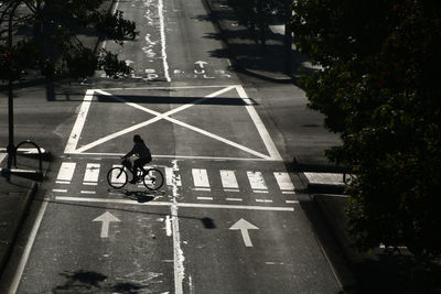 Man riding bicycle on road in city