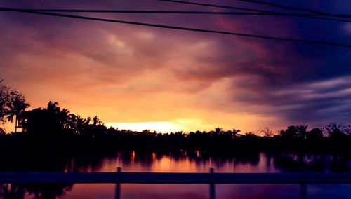 Scenic view of silhouette trees against sky at sunset