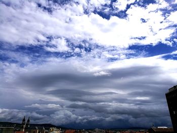 Low angle view of storm clouds over city