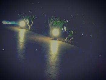 Illuminated tunnel at night