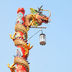 Low angle view of sculpture against clear sky