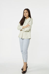 Portrait of a smiling young woman against white background