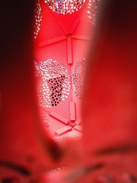 Low angle view of illuminated light on pink window