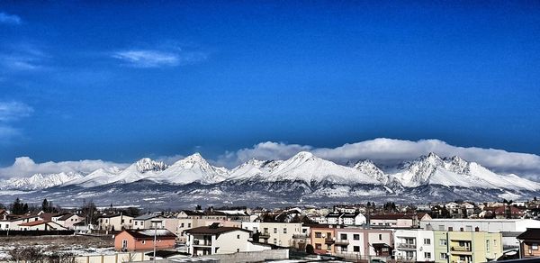 Townscape against mountains during winter