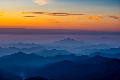 Scenic view of silhouette mountains against sky during sunset