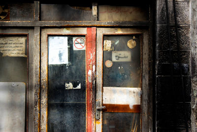 Closed glass door of abandoned building