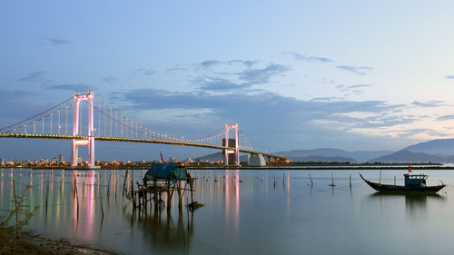 View of suspension bridge against cloudy sky