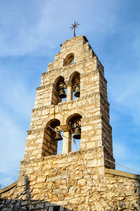 Low angle view of bell tower against sky