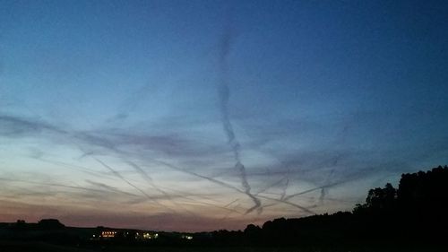 Low angle view of silhouette trees against sky at sunset