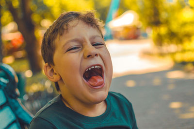 Close-up portrait of boy screaming in park