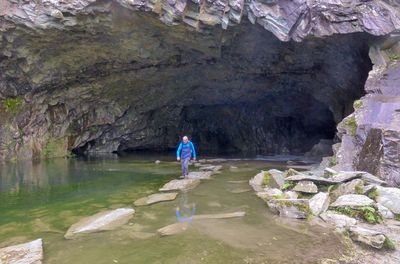 Rear view of man standing on rock