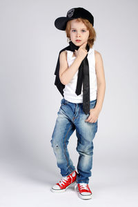 Portrait of boy standing against white background