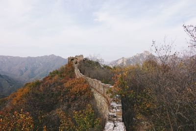 Scenic view of mountains against cloudy sky