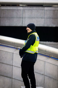 Rear view of man standing against wall