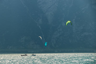 People paragliding over sea