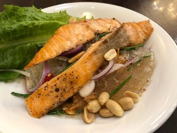 High angle view of salmon fish slice food in plate on table 