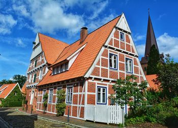 Residential buildings in town against sky