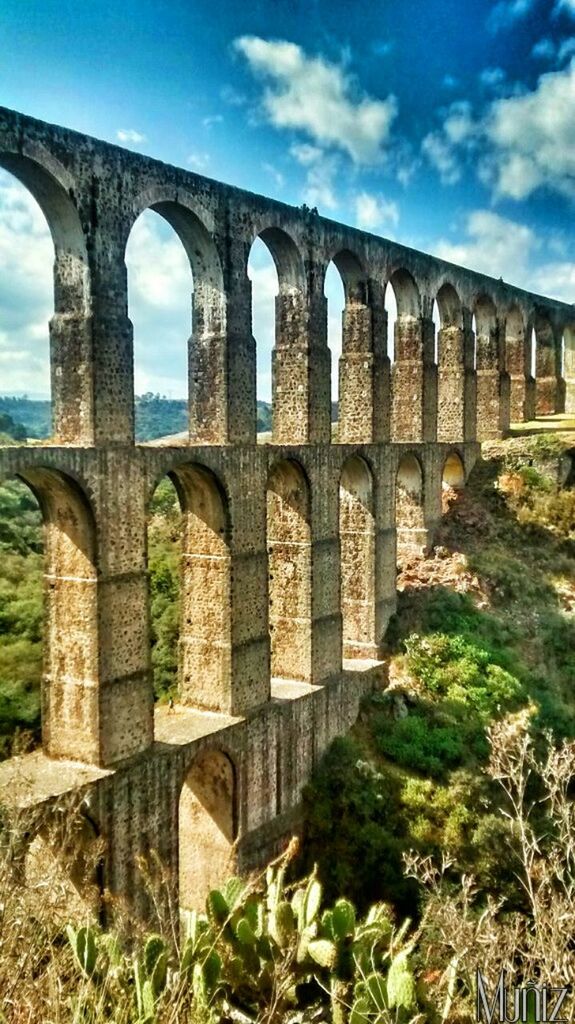 architecture, built structure, arch, connection, bridge - man made structure, history, old ruin, international landmark, famous place, sky, arch bridge, ancient, the past, engineering, travel destinations, architectural column, bridge, travel, ancient civilization, low angle view