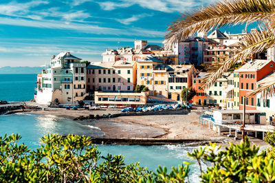 View of city by sea against sky