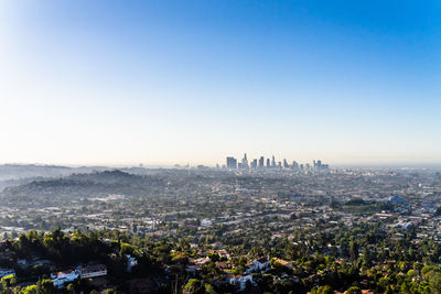 Aerial view of city buildings against clear sky