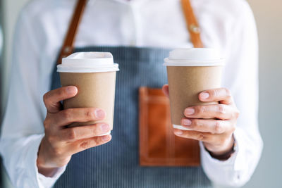 Cropped image of woman holding coffee cup
