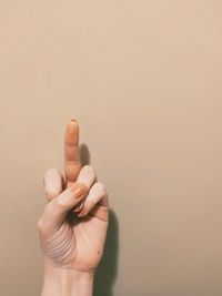 Close-up of person holding hand over black background