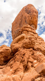 Low angle view of rock formation against sky