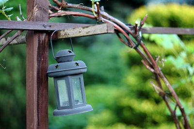 Close-up of birdhouse on wooden post