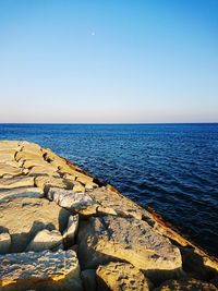 Scenic view of sea against clear blue sky