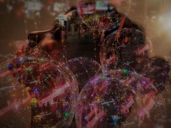 Digital composite image of people at illuminated city