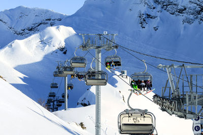 A chairlift with snowboarders and skiers in the snowy mountains. winter sports during the vacations