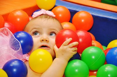 Portrait of cute boy playing with balloons