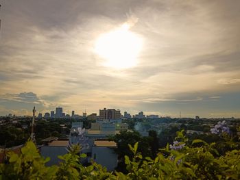 Scenic view of city against sky during sunset